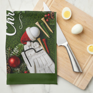 Golf Christmas themed on green grass Tea Towel