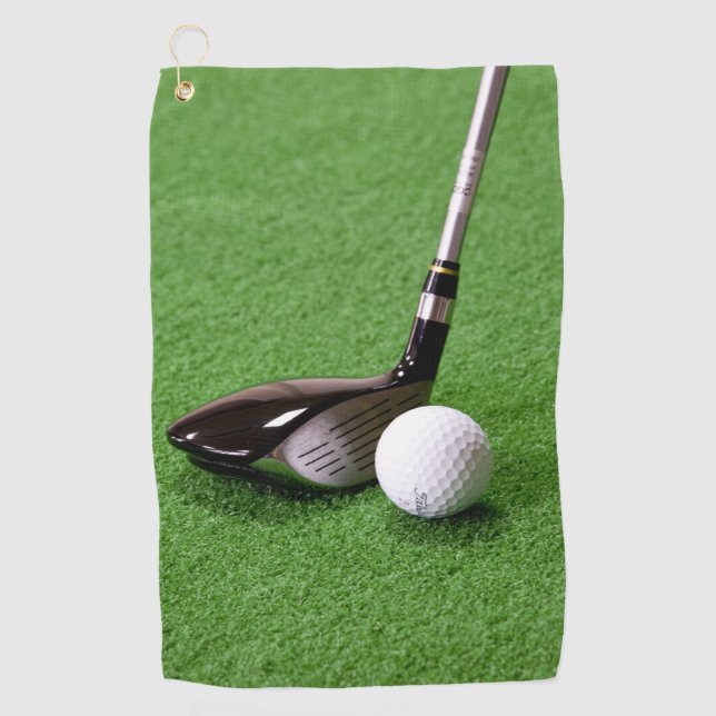 Golf club and ball on a green surface Golf Towels (Front)
