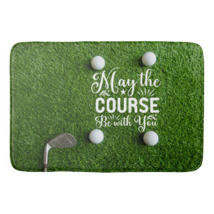 Golfer's bathroom with golf balls on green grass bath mat