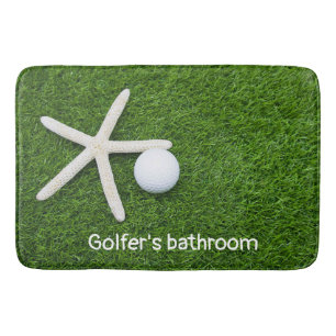 Golfer's bathroom with golf balls on green grass   bath mat