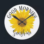 Good Morning Sunshine Sunflower Round Clock<br><div class="desc">A close-up photo of a bright yellow sunflower with text "Good Morning Sunshine" on white background. If you want to,  you can replace the word Sunshine with a name or other text.</div>