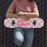Good Vibes Girly Pastel Pink White Chequered Patte Skateboard<br><div class="desc">Another girly skateboard by JessicaAmber - message me about custom orders! This fun skateboard features a pastel pink and white chequerboard design. The pattern has a wavy distortion to it, giving a fun and youthful vibe. The slogan in the middle says 'good vibes' in a chunky retro font with a...</div>