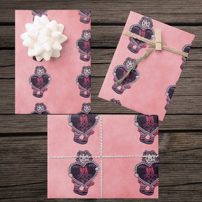 Gothic Cloth Dolls Big black Heart Bow Pinks Wrapping Paper Sheet (Gothic rag doll holding black heart with red bow trimmed in lace on mix of pink gift wrapping papers)