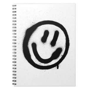 graffiti smiling face emoticon in black on whitesp notebook