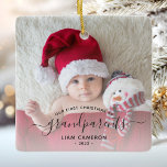 Grandparents First Christmas Photo Black Script Ceramic Ornament<br><div class="desc">Help them celebrate their first grandchild with this beautiful modern keepsake ornament. The off-black text reads "Our first Christmas as grandparents, " with the word "grandparents" in elegant handwriting script with flourishes before and after. Easily replace the sample image with your favourite photo of the new baby, and add his...</div>