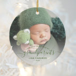 Grandparents First Christmas Photo Green Script Ceramic Ornament<br><div class="desc">Help them celebrate their first grandchild with this beautiful modern keepsake ornament. The green text reads "Our first Christmas as grandparents, " with the word "grandparents" in elegant handwriting script with flourishes before and after. Easily replace the sample image with your favorite photo of the new baby, and add his...</div>