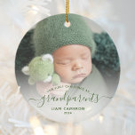 Grandparents First Christmas Photo Green Script Ceramic Ornament<br><div class="desc">Help them celebrate their first grandchild with this beautiful modern keepsake ornament. The green text reads "Our first Christmas as grandparents, " with the word "grandparents" in elegant handwriting script with flourishes before and after. Easily replace the sample image with your favourite photo of the new baby, and add his...</div>