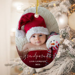 Grandparents First Christmas Photo White Script Ceramic Ornament<br><div class="desc">Help them celebrate their first grandchild with this beautiful modern keepsake ornament. The white text reads "Our first Christmas as grandparents, " with the word "grandparents" in elegant handwriting script with flourishes before and after. Easily replace the sample image with your favorite photo of the new baby, and add his...</div>