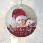 Grandparents First Christmas Photo White Script Ceramic Ornament<br><div class="desc">Help them celebrate their first grandchild with this beautiful modern keepsake ornament. The white text reads "Our first Christmas as grandparents, " with the word "grandparents" in elegant handwriting script with flourishes before and after. Easily replace the sample image with your favourite photo of the new baby, and add his...</div>