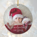 Grandparents First Christmas Photo White Script Ceramic Ornament<br><div class="desc">Help them celebrate their first grandchild with this beautiful modern keepsake ornament. The white text reads "Our first Christmas as grandparents, " with the word "grandparents" in elegant handwriting script with flourishes before and after. Easily replace the sample image with your favourite photo of the new baby, and add his...</div>