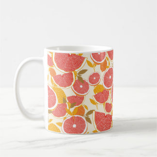 Grapefruit and halved slices with leaves on white. coffee mug