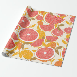 Grapefruit and halved slices with leaves on white. wrapping paper