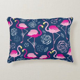 Graphic pattern of pink flamingos on a dark blue b decorative cushion