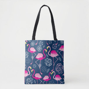 Graphic pattern of pink flamingos on a dark blue b tote bag