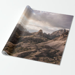 GRASS FIELD NEAR HILLS UNDER CLOUDY SKY AT DAYTIME WRAPPING PAPER