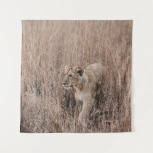GRAY AND BROWN LION SURROUNDED BY BROWN GRASS TAPESTRY