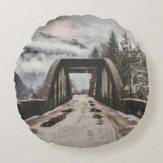 GRAY CONCRETE ARCH BRIDE BESIDE LEAFLESS TREE NEAR ROUND CUSHION