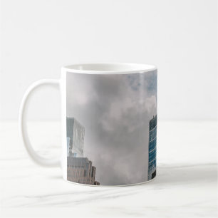 GRAY CONCRETE BUILDING UNDER CLOUDY SKY DURING DAY COFFEE MUG