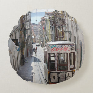 GRAY TRAM ON RAILWAY ALONG THE BUILDING ROUND CUSHION