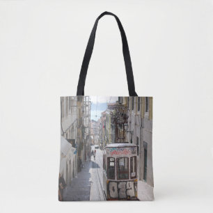 GRAY TRAM ON RAILWAY ALONG THE BUILDING TOTE BAG