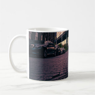 GRAY VEHICLE AT ROAD BESIDE CONCRETE BUILDING COFFEE MUG