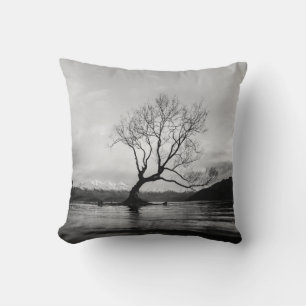 GRAYSCALE PHOTO OF BARE TREE ON CALM BODY OF WATER CUSHION
