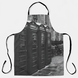GRAYSCALE PHOTO OF FOUR TELEPHONE BOOTHS LINED UP APRON