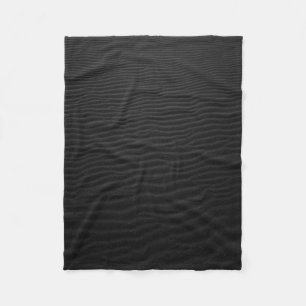 Grayscale photography of sand fleece blanket