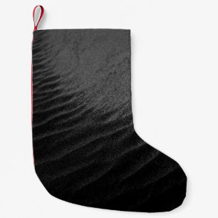GRAYSCALE PHOTOGRAPHY OF SAND SMALL CHRISTMAS STOCKING