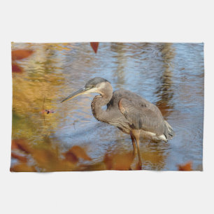 Great Blue Heron framed with fall foliage Tea Towel