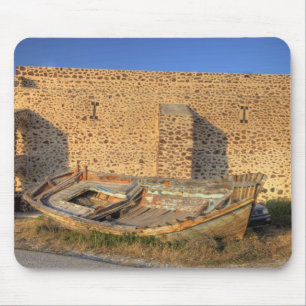 Greece, Santorini, Oia. Old fishing boat on dry Mouse Pad