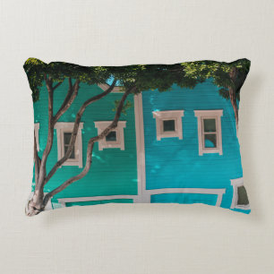 Green and blue houses beside trees on sidewalk decorative cushion