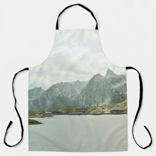 GREEN AND BROWN MOUNTAINS NEAR BODY OF WATER UNDER APRON