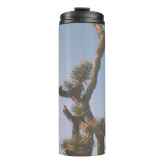 GREEN AND BROWN TREE UNDER BLUE SKY THERMAL TUMBLER