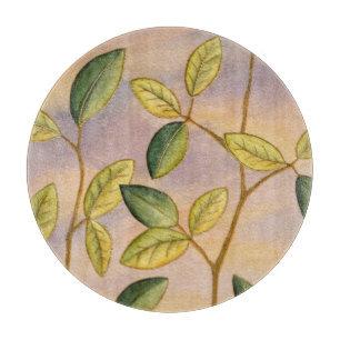 Green and Yellow Leaves on Sunset Background Cutting Board