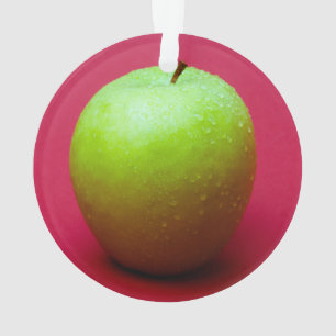 Green apple on red background ornament