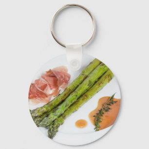 Green asparagus with ham and sauce key ring