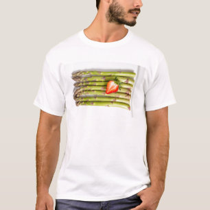 Green asparagus with strawberries top view