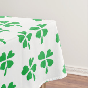 Green clover leaves pattern on white tablecloth