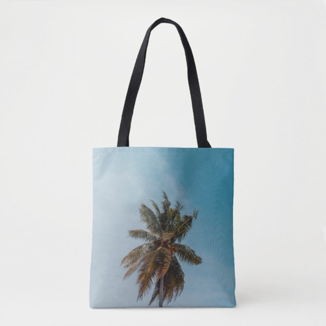 Green coconut tree under blue sky tote bag (Front)