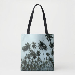 Green coconut trees under white sky in the morning tote bag