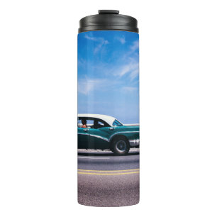 Green coupe on grey asphalt road thermal tumbler