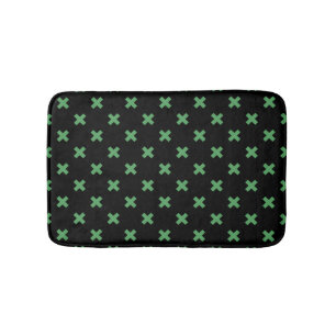 Green cross stitches on black bath mat