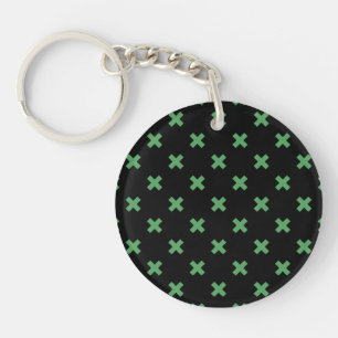 Green cross stitches on black key ring