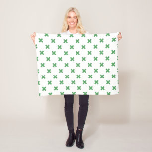 Green cross stitches on white fleece blanket