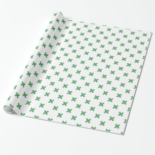 Green cross stitches on white wrapping paper