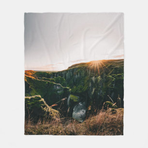 GREEN GRASS FIELD AND MOUNTAIN DURING DAYTIME FLEECE BLANKET