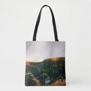 GREEN GRASS FIELD AND MOUNTAIN DURING DAYTIME TOTE BAG