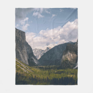 GREEN GRASS FIELD NEAR ROCKY MOUNTAIN UNDER WHITE FLEECE BLANKET