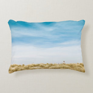 Green grass field under blue skies decorative cushion